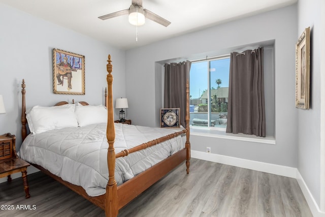 bedroom with wood finished floors, baseboards, and ceiling fan