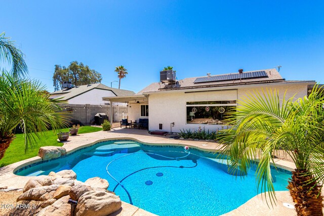 view of swimming pool featuring a patio, a fenced backyard, and central AC unit