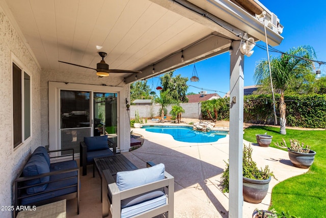 view of swimming pool with a patio, a fenced backyard, a ceiling fan, and an outdoor hangout area