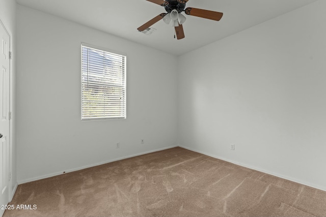 spare room featuring ceiling fan and carpet