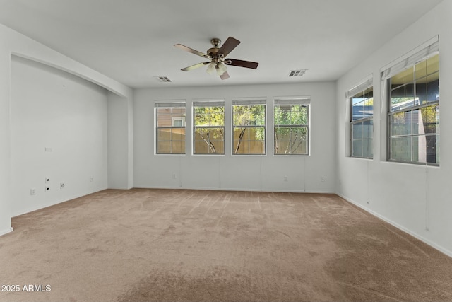 spare room with ceiling fan and light colored carpet