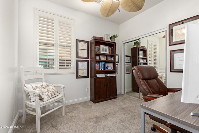 carpeted office featuring ceiling fan