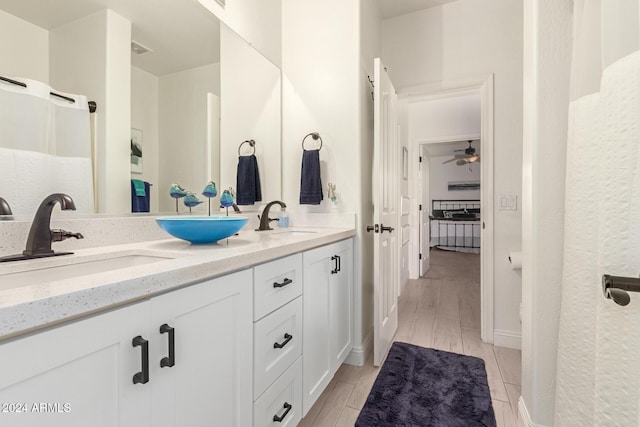 bathroom featuring wood-type flooring, vanity, and ceiling fan