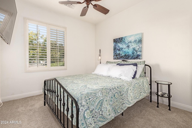 bedroom featuring light colored carpet and ceiling fan