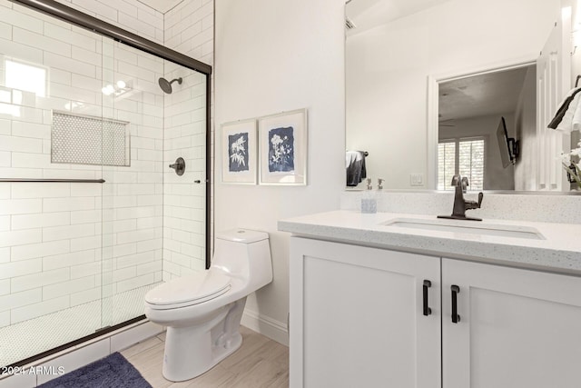 bathroom featuring a baseboard radiator, walk in shower, hardwood / wood-style floors, toilet, and vanity