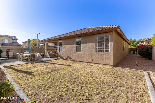 back of property featuring a patio area