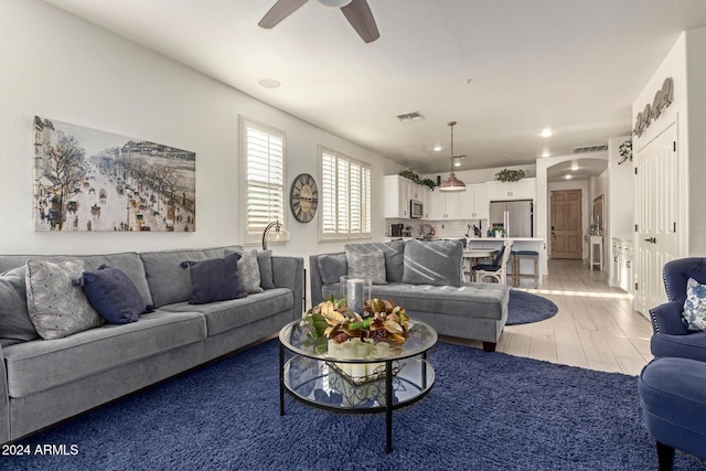 living room with ceiling fan and hardwood / wood-style flooring