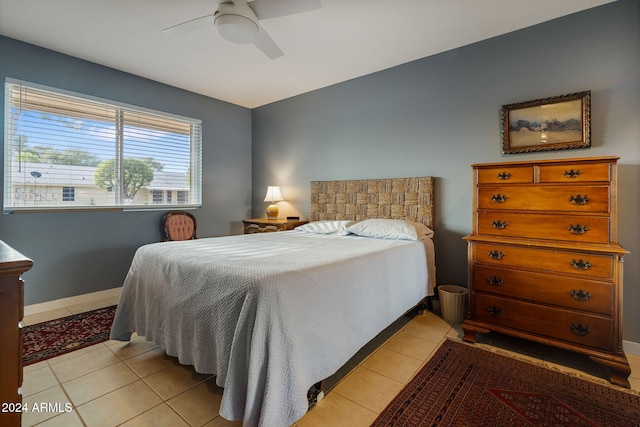 bedroom with ceiling fan and light tile patterned flooring