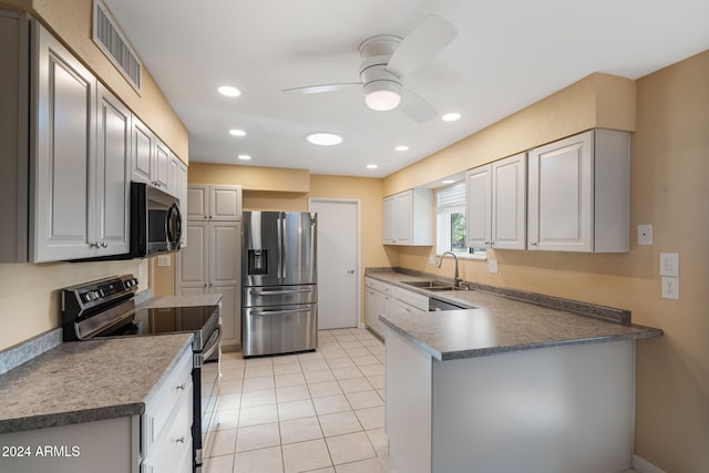 kitchen with ceiling fan, sink, light tile patterned floors, white cabinets, and appliances with stainless steel finishes