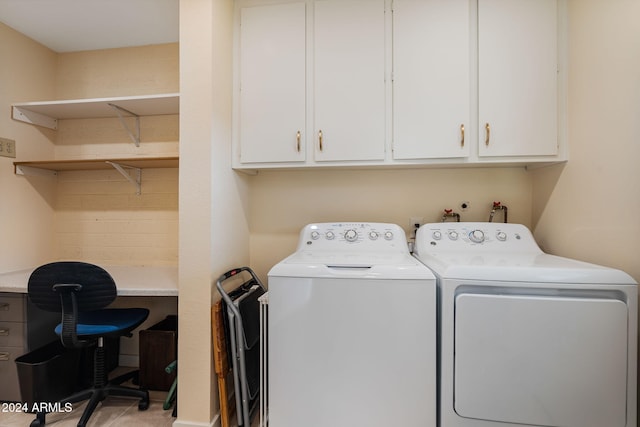 laundry room with washer and dryer and cabinets