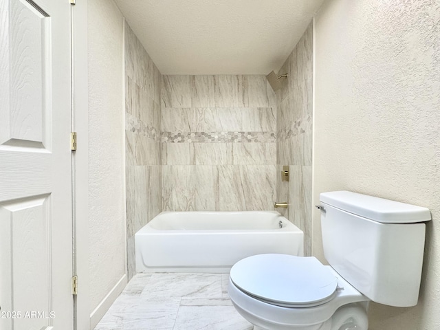 bathroom with shower / bath combination, toilet, a textured wall, and a textured ceiling