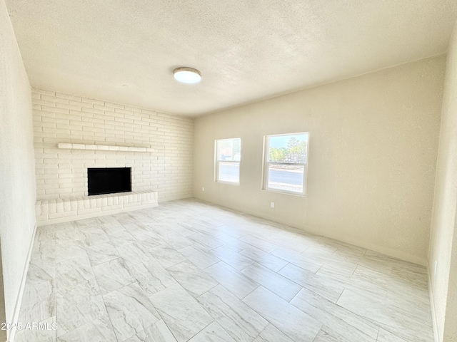 unfurnished living room featuring a fireplace and a textured ceiling
