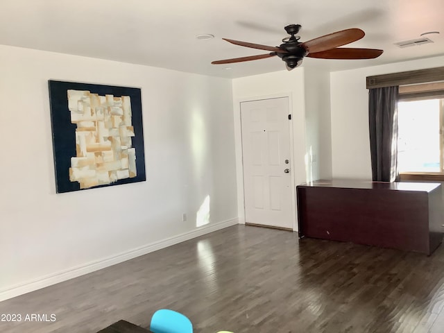 interior space with ceiling fan and dark wood-type flooring