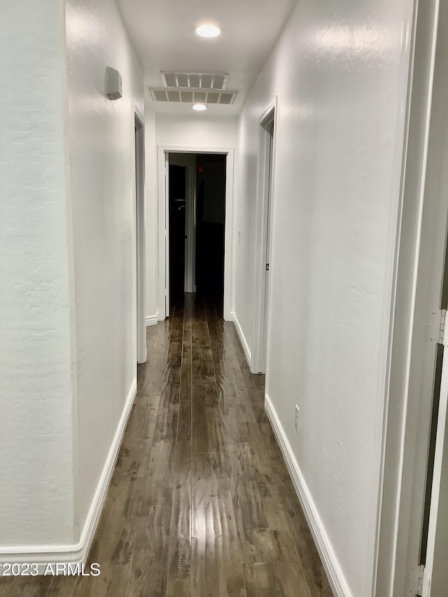 hall with dark wood-type flooring