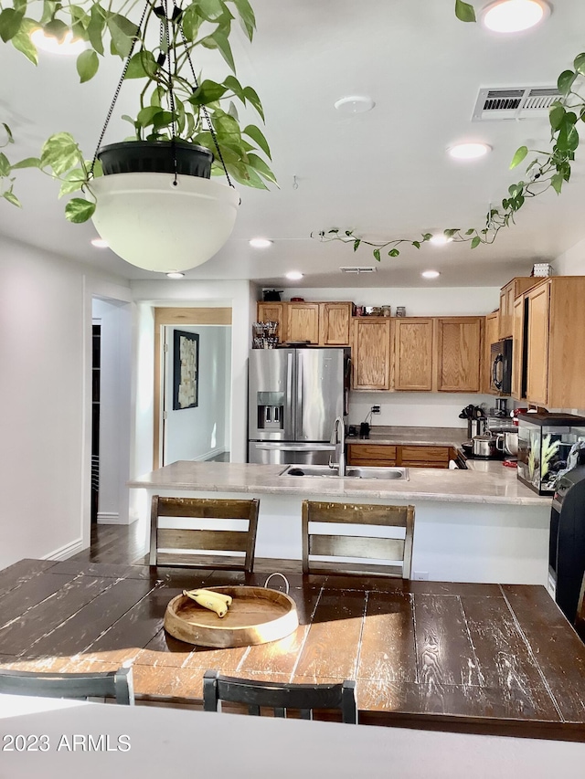 kitchen with appliances with stainless steel finishes, dark wood-type flooring, and sink