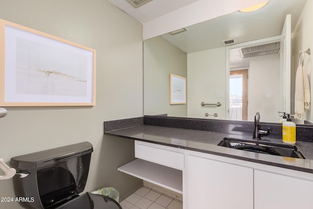 bathroom featuring tile patterned flooring, vanity, and toilet