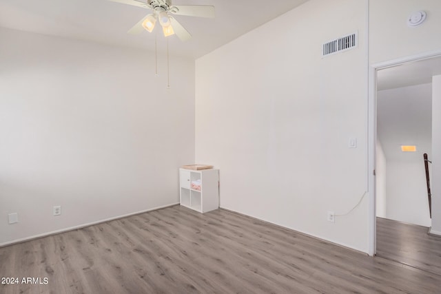 empty room with light hardwood / wood-style floors and ceiling fan