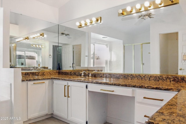 bathroom with lofted ceiling, a shower stall, ceiling fan, and vanity