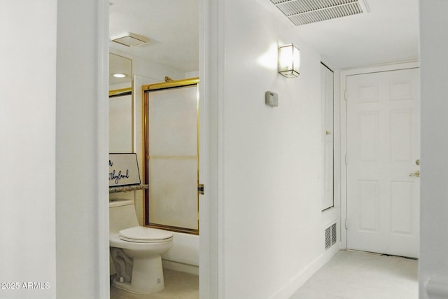 bathroom with visible vents, toilet, and shower / bath combination with glass door