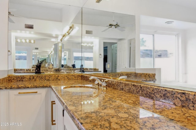 bathroom with visible vents, vanity, and a ceiling fan