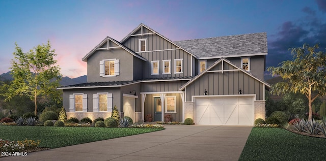 view of front of home featuring a lawn and a garage