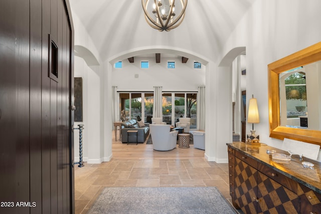 foyer with a notable chandelier and a towering ceiling