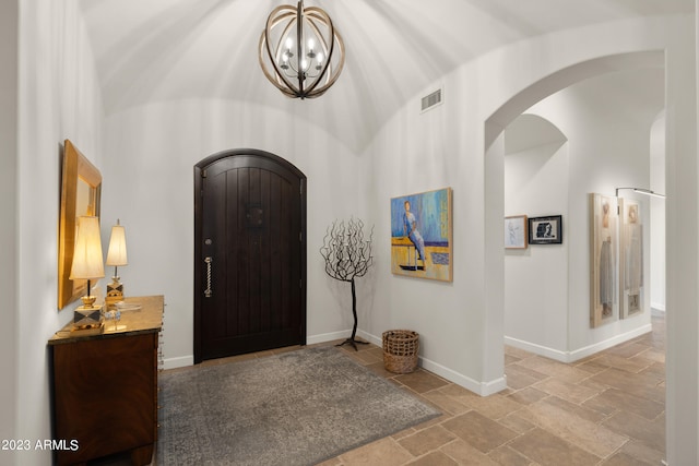 entrance foyer with an inviting chandelier and lofted ceiling