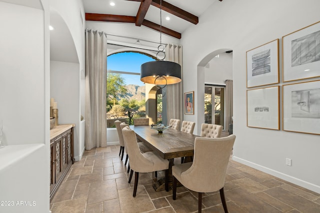 dining area featuring high vaulted ceiling, beam ceiling, and a healthy amount of sunlight