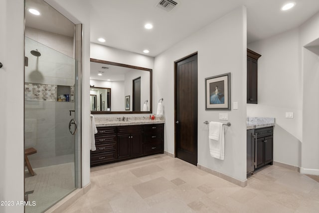 bathroom featuring vanity and an enclosed shower