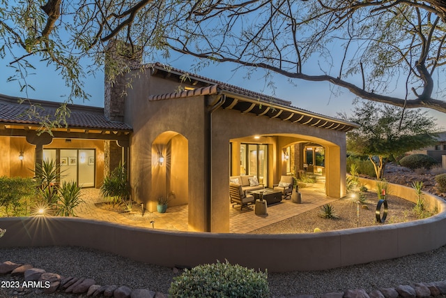 rear view of house featuring an outdoor hangout area and a patio area