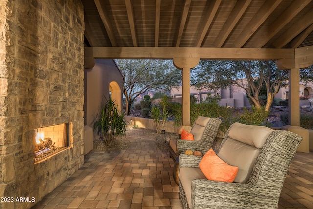 patio terrace at dusk featuring an outdoor living space with a fireplace