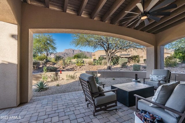 view of patio / terrace featuring ceiling fan, a mountain view, and an outdoor hangout area