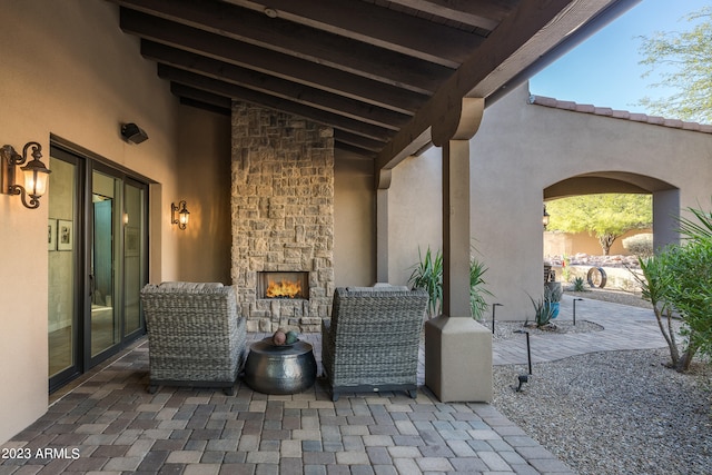 view of patio / terrace with an outdoor stone fireplace