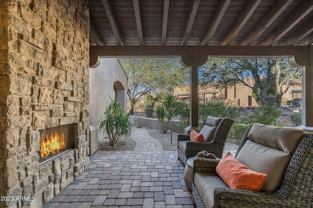 view of patio / terrace featuring an outdoor living space with a fireplace