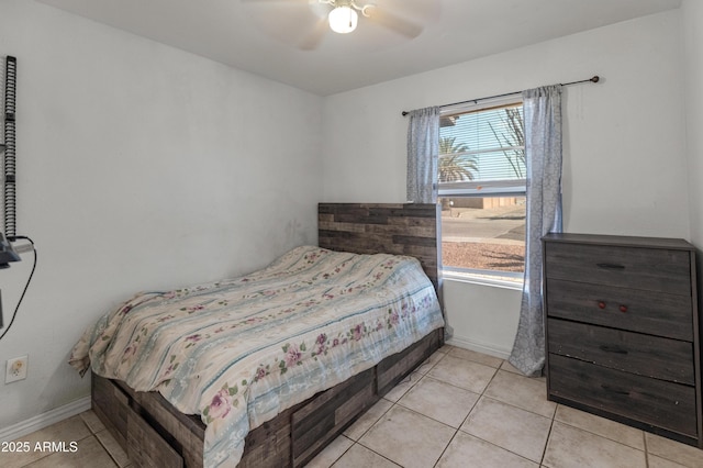 bedroom with light tile patterned floors, multiple windows, and baseboards