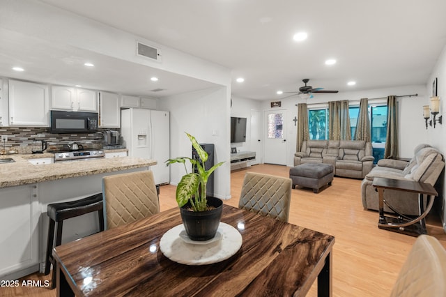 dining area featuring ceiling fan, light wood-style flooring, visible vents, and recessed lighting