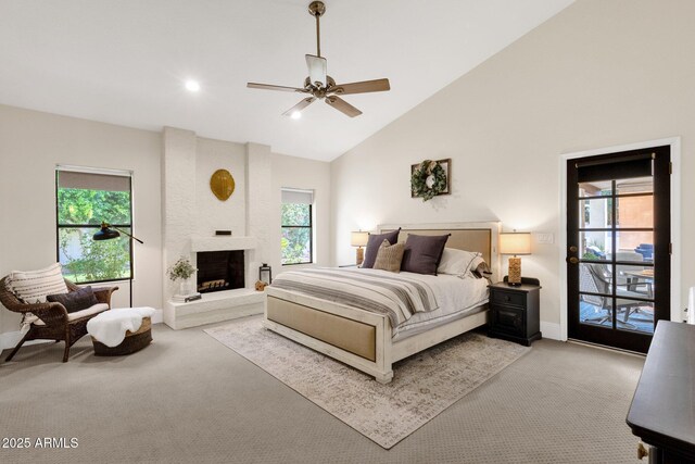 9821 E Windrose Dr, Scottsdale, AZ 85260 - bedroom with light carpet, multiple windows, a large fireplace, high vaulted ceiling, and recessed lighting
