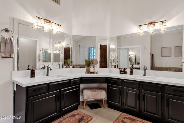 9821 E Windrose Dr, Scottsdale, AZ 85260 - full bath with vanity, tile patterned flooring, and a chandelier