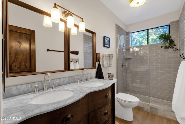 9821 E Windrose Dr, Scottsdale, AZ 85260 - full bath with double vanity, tiled shower, and wood finished floors