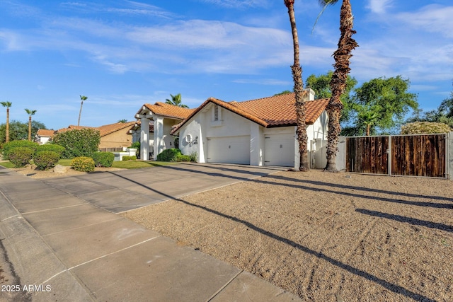 9821 E Windrose Dr, Scottsdale, AZ 85260 - mediterranean / spanish-style home featuring concrete driveway, stucco siding, a garage, and a tiled roof