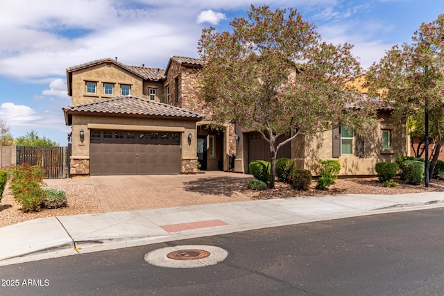 23126 N 45th Pl, Phoenix, AZ 85050 - view of front of house with stone siding, decorative driveway, and a garage