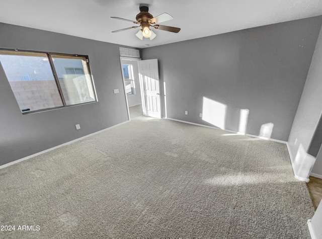 carpeted spare room with ceiling fan