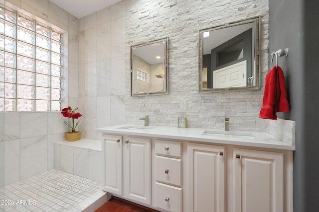 bathroom with tile walls, a healthy amount of sunlight, and vanity