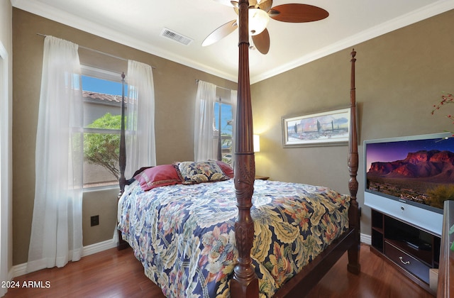 bedroom with dark hardwood / wood-style flooring, crown molding, and ceiling fan