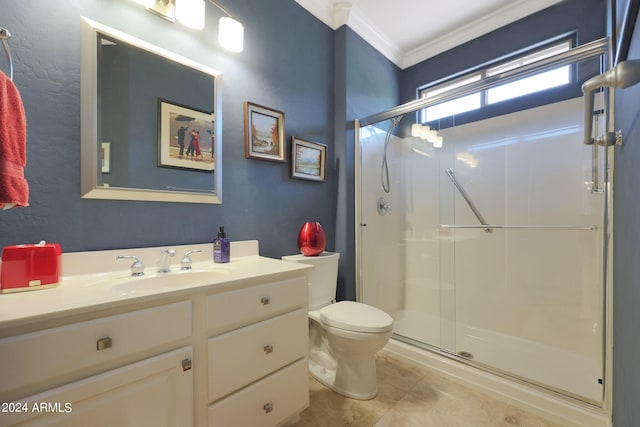 bathroom featuring toilet, vanity, tile patterned floors, crown molding, and a shower with shower door