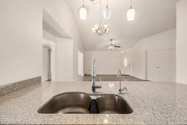 6621 S Coral Gable Dr, Chandler, AZ 85249 - kitchen with a sink, light stone countertops, a chandelier, vaulted ceiling, and a ceiling fan