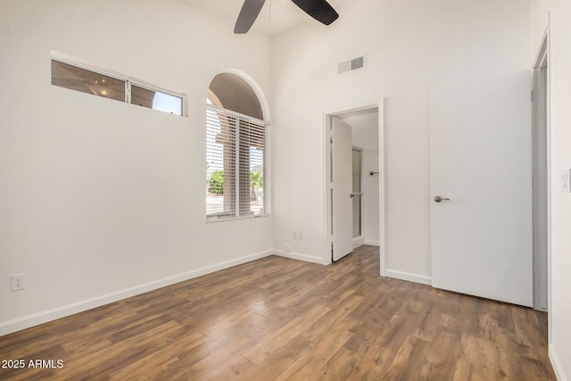 6621 S Coral Gable Dr, Chandler, AZ 85249 - spare room featuring a ceiling fan, wood finished floors, a high ceiling, and baseboards