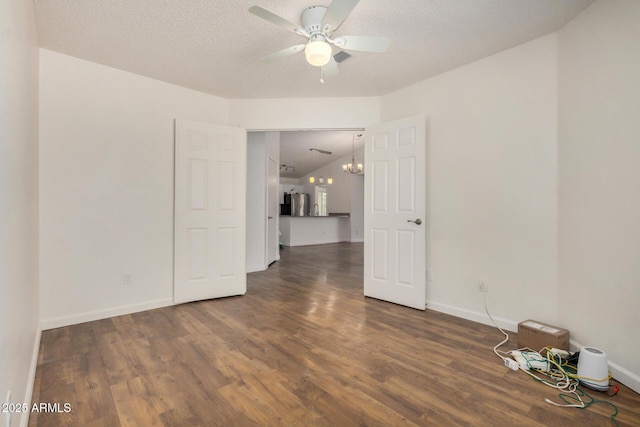 6621 S Coral Gable Dr, Chandler, AZ 85249 - empty room with ceiling fan, wood finished floors, a chandelier, baseboards, and a textured ceiling