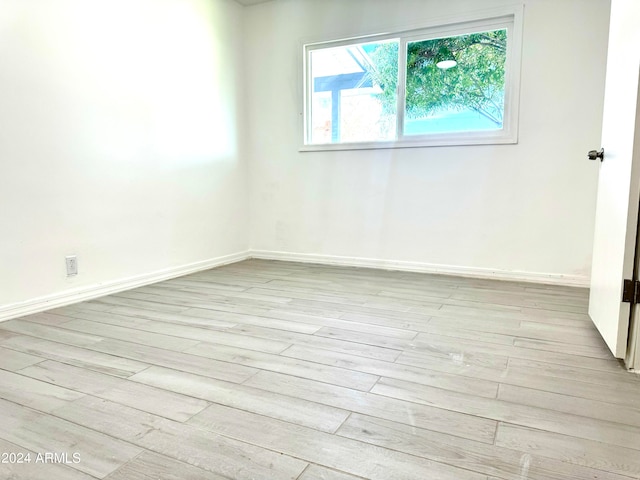 spare room featuring light hardwood / wood-style floors