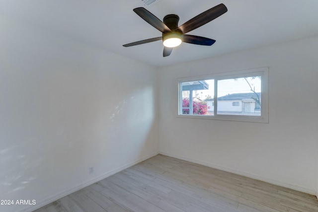 empty room with light wood-type flooring and ceiling fan